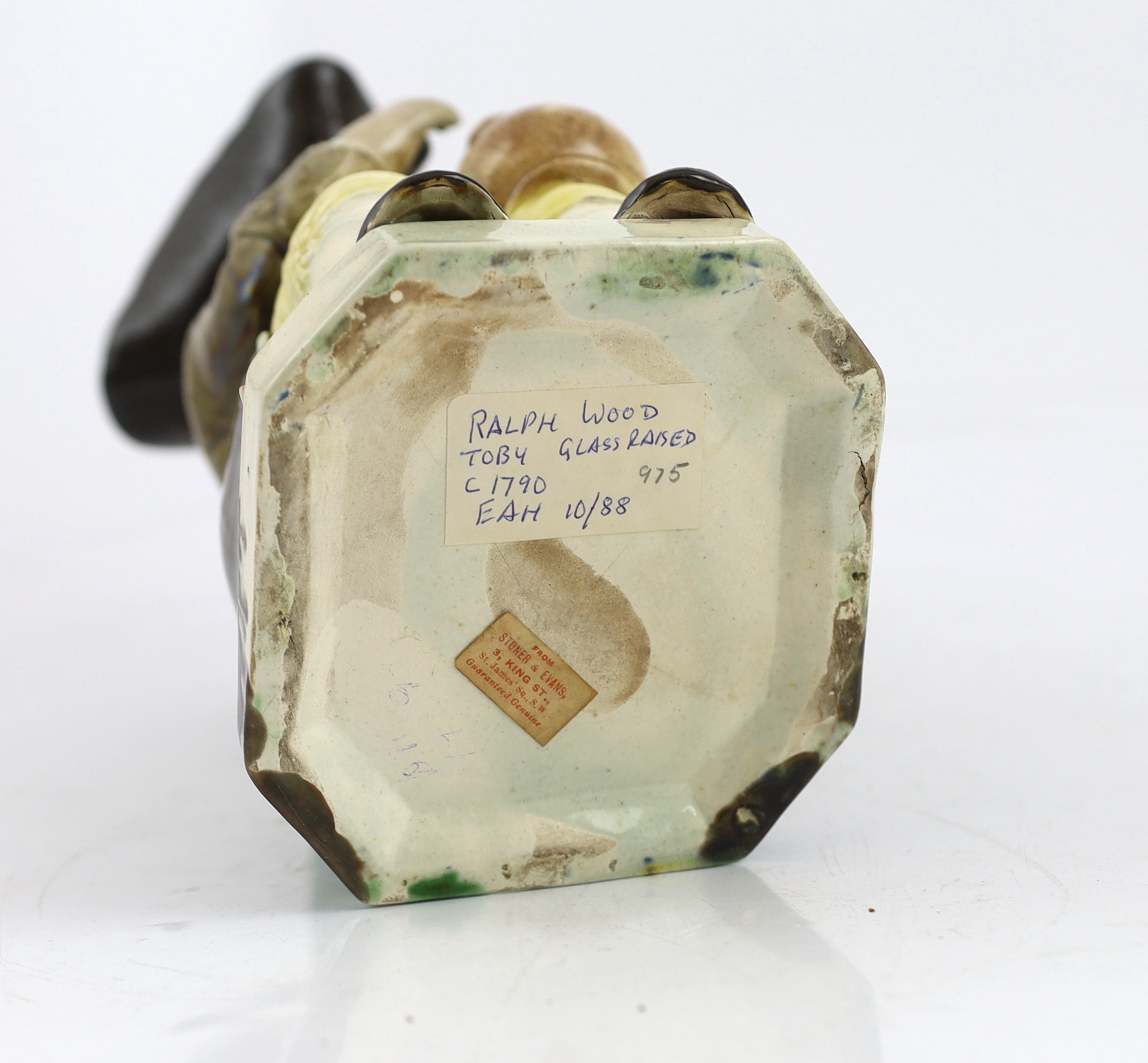 A Ralph Wood type creamware Toby jug of standard type, raising a glass to his lips, c.1790, glaze losses to rim